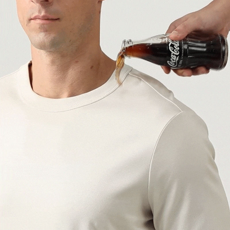 Liquid rolling off engineered stain-repellent fabric — laundry-saving fabric demo